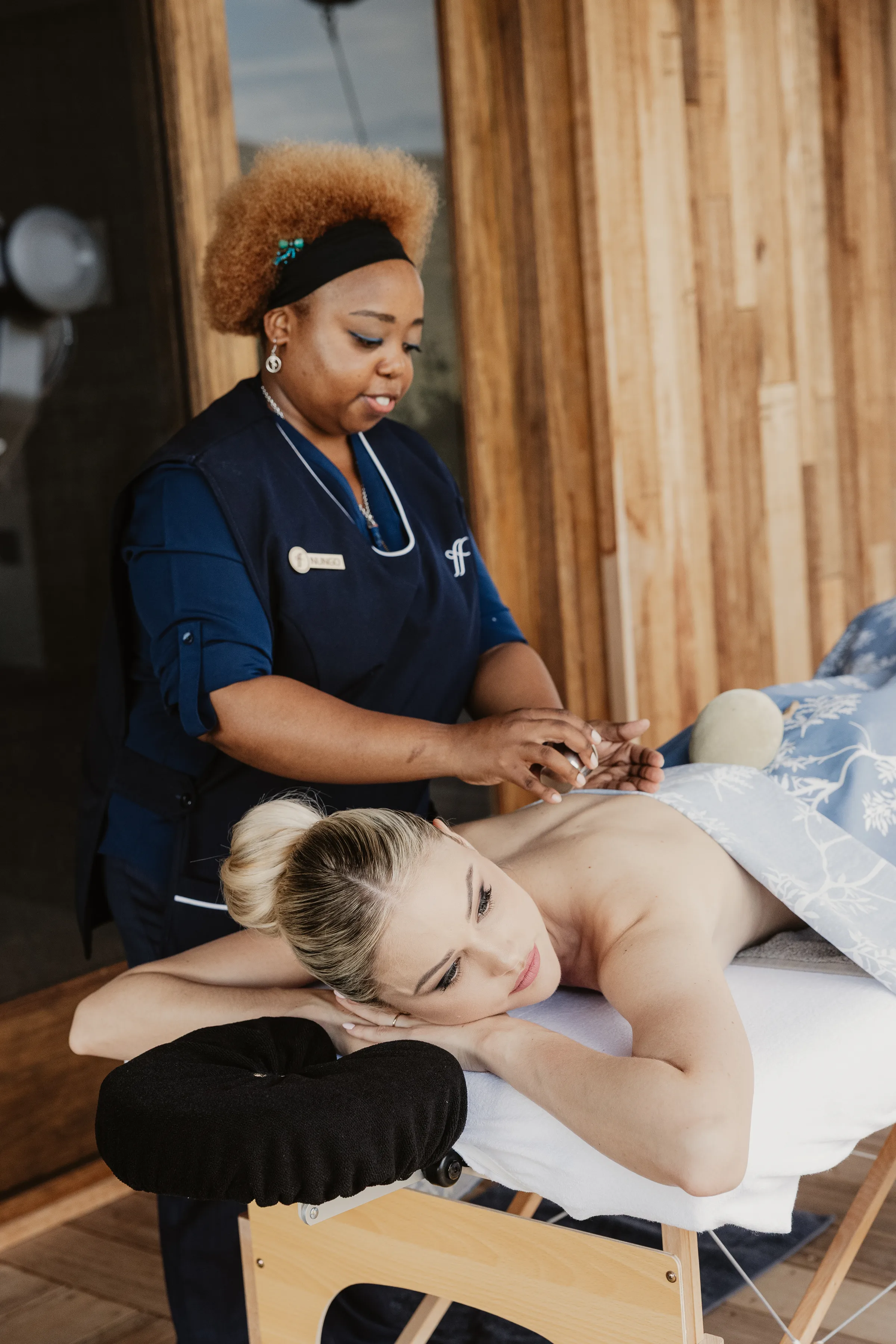 Nungo giving massage to guest in room