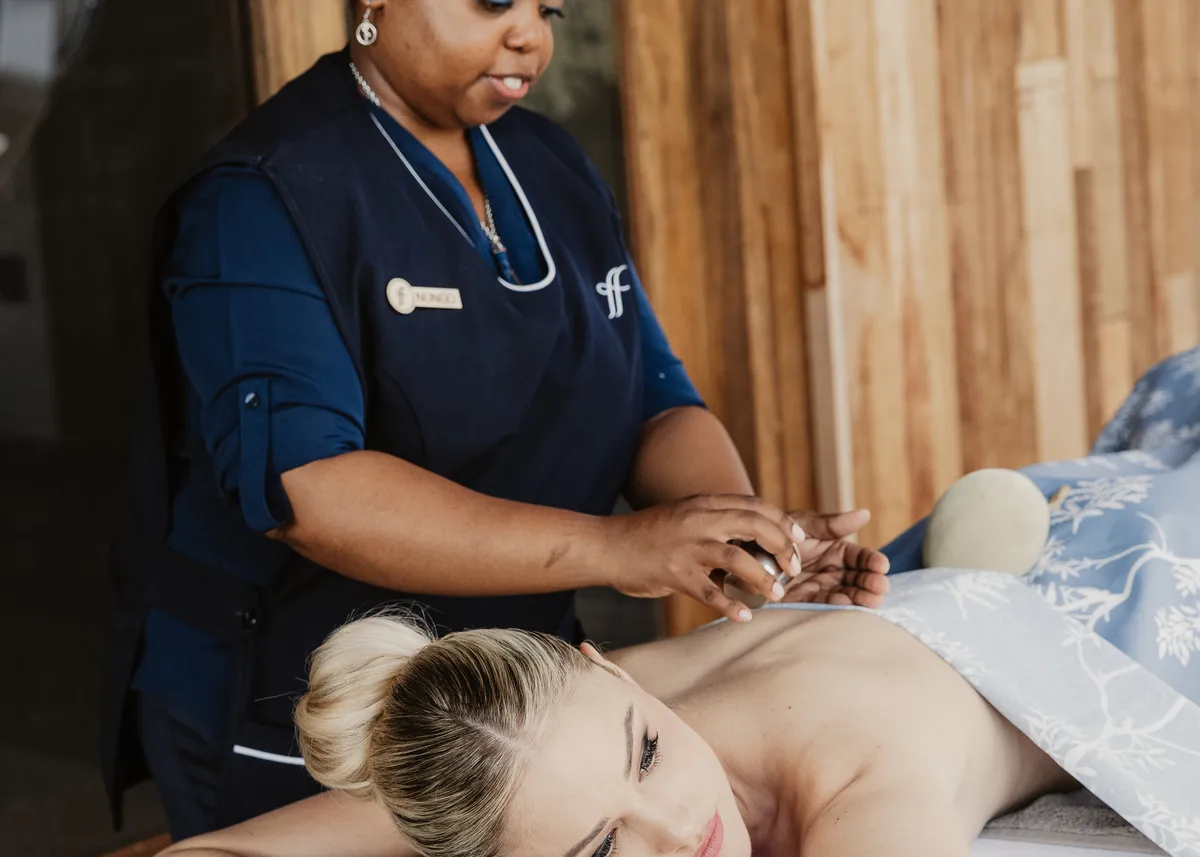 Nungo giving massage to guest in room