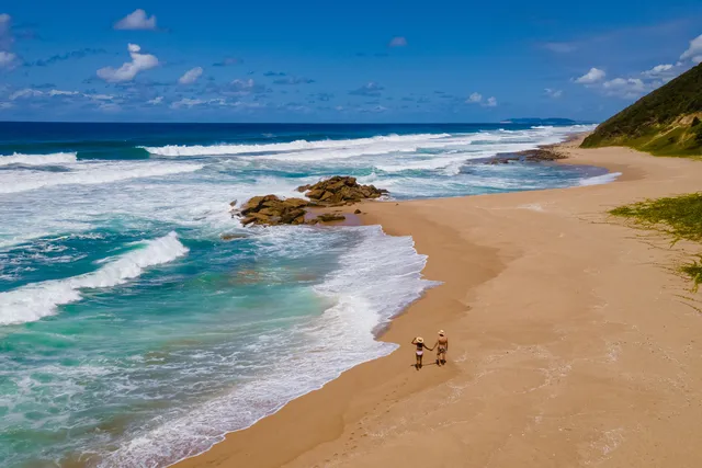 St Lucia South Africa, men and woman walking at the beach Mission Rocks beach near Cape Vidal in Isimangaliso Wetland Park in Zululand. South Africa St Lucia
